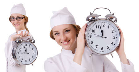 Attractive woman doctor with big clock  isolated on whiteの写真素材