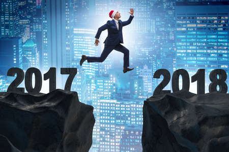 Businessman in santa hat jumping from 2017 to 2018の写真素材