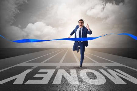 Young businessman chasing money in financial business conceptの写真素材