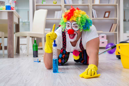 Funny clown doing cleaning at homeの写真素材