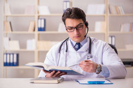 Young man doctor in medical conceptの写真素材