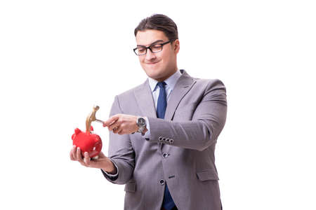 Businessman breaking piggybank isolated white backgroundの写真素材