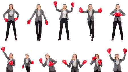Woman businesswoman with boxing gloves on whiteの写真素材