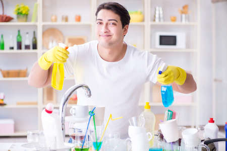 Man enjoying dish washing chores at home