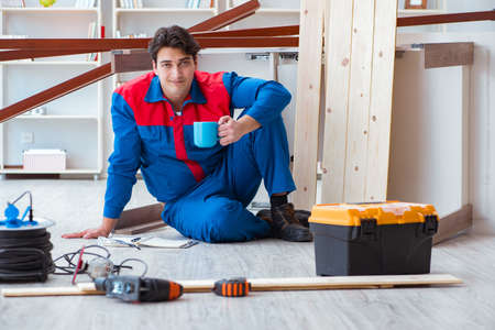 Young carpenter with notebook writing planning at construction rの写真素材