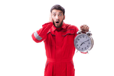 Young repairman with an alarm clock isolated on white background