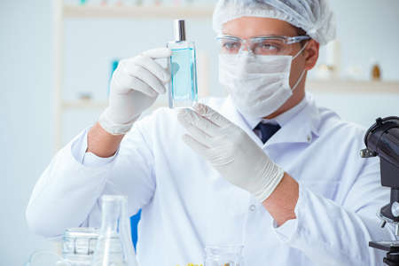 Chemist mixing perfumes in the lab