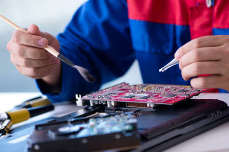 Repairman working in technical support fixing computer laptop tr
