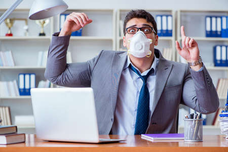 Businessman sweating excessively smelling bad in office at workpの写真素材