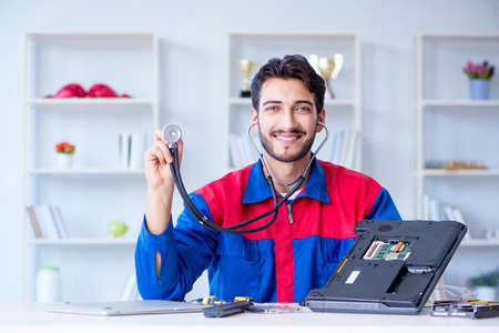 Repairman working in technical support fixing computer laptop tr