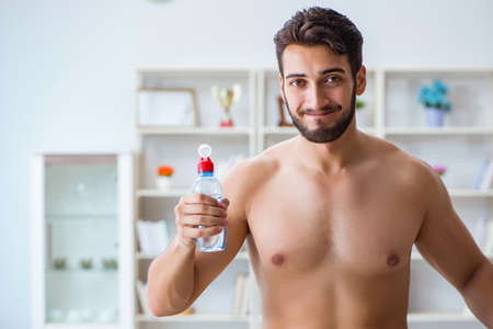 Man in oversized pants in weight loss conceptの写真素材