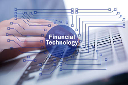 Hands working on laptop in financial technology fintech concept