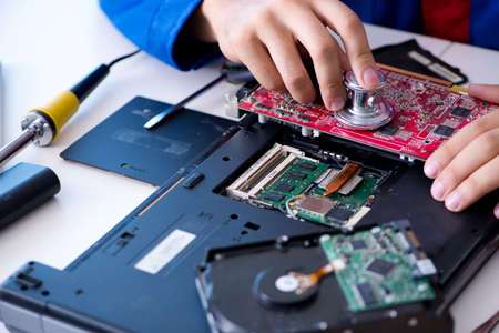 Repairman working in technical support fixing computer laptop tr