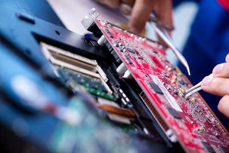 Repairman working in technical support fixing computer laptop tr