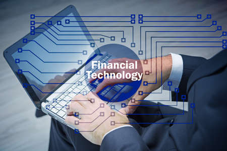 Hands working on laptop in financial technology fintech concept