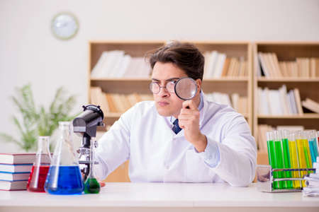 Mad crazy scientist doctor doing experiments in a laboratoryの写真素材