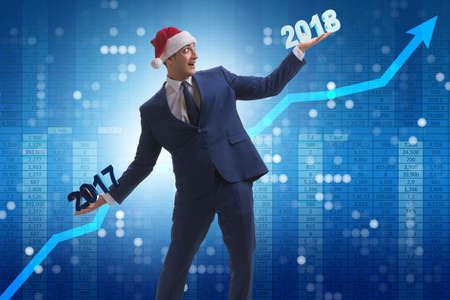 Businessman in santa hat holding 2017 and 2018の写真素材