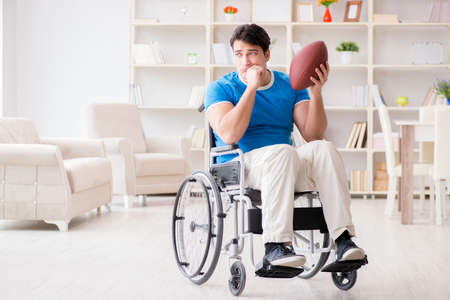 Young man american football player recovering on wheelchair