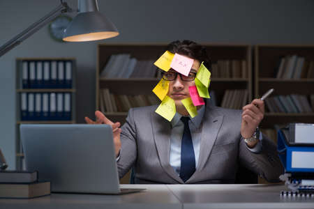 Businessman staying late to sort out prioritiesの写真素材