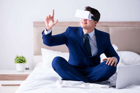 Businessman wearing a virtual reality headset in the bedroom