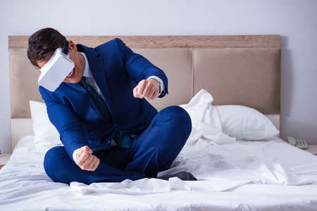 Businessman wearing a virtual reality headset in the bedroomの写真素材