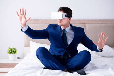 Businessman wearing a virtual reality headset in the bedroom