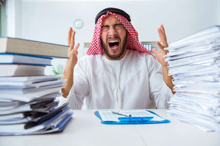 Arab businessman working in the office doing paperwork with a piの写真素材