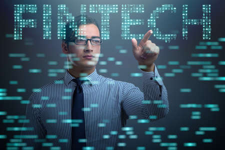 Businessman pressing buttons in fintech conceptの写真素材