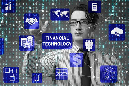 Businessman pressing buttons in fintech conceptの写真素材