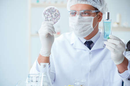Chemist mixing perfumes in the labの写真素材
