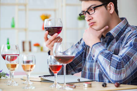 Professional sommelier tasting red wineの写真素材