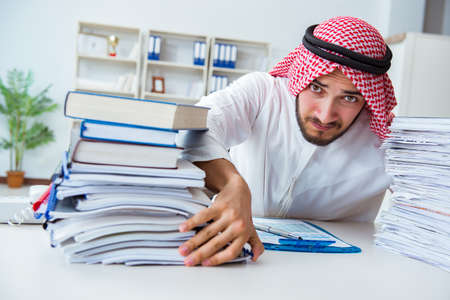Arab businessman working in the office doing paperwork with a piの写真素材