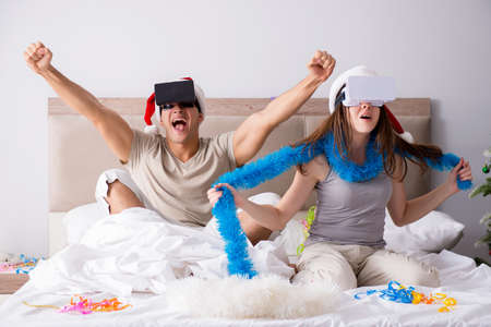 Happy couple celebrating christmas holiday in bed