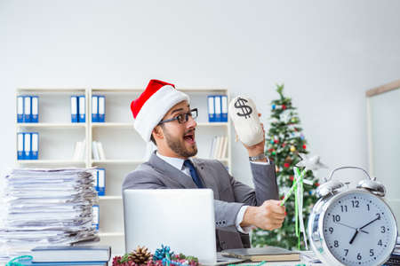 Young businessman celebrating christmas in the officeの写真素材