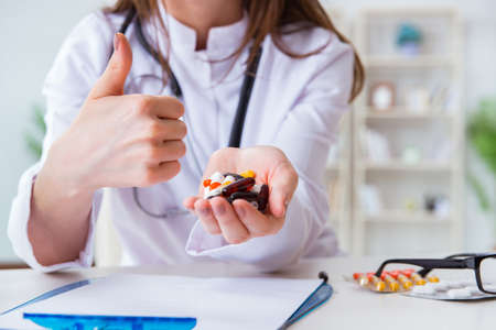 Doctor with pills working in hospitalの写真素材