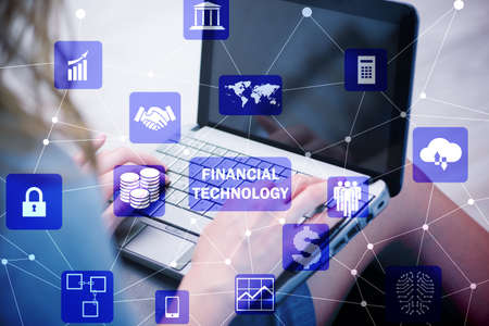 Hands working on laptop in financial technology fintech conceptの写真素材