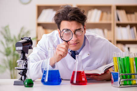 Mad crazy scientist doctor doing experiments in a laboratoryの写真素材