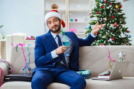 Businessman working at home during christmasの写真素材