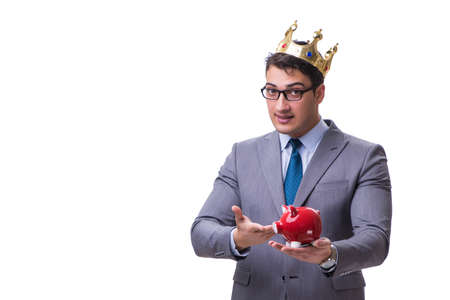 King businessman holding a piggy bank isolated on white backgrouの写真素材