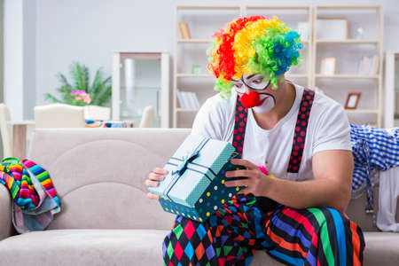 Drunk clown celebrating having a party at homeの写真素材