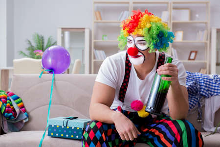 Drunk clown celebrating having a party at homeの写真素材