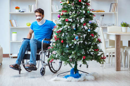 Injured disabled man celebrating christmas at homeの写真素材