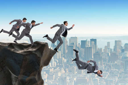 Business people falling off the cliffの写真素材