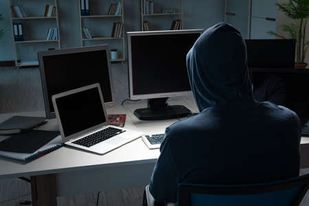 Hacker hacking computer at night