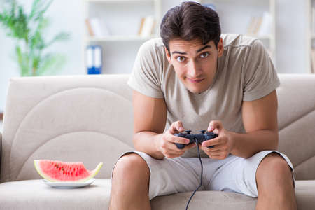 Man eating watermelon at home