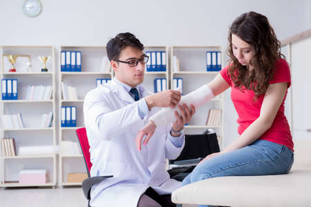 Doctor and patient during check-up for injury in hospitalの写真素材