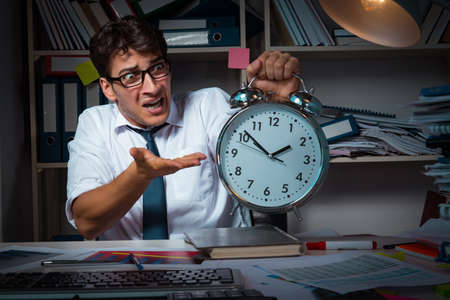 Man businessman working late hours in the officeの写真素材