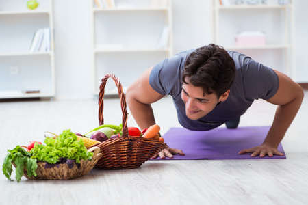 Man promoting the benefits of healthy eating and doing sportsの写真素材
