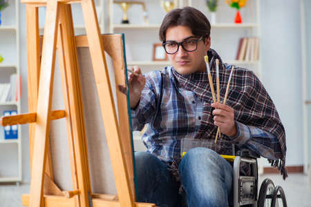 Disabled artist painting picture in studioの写真素材