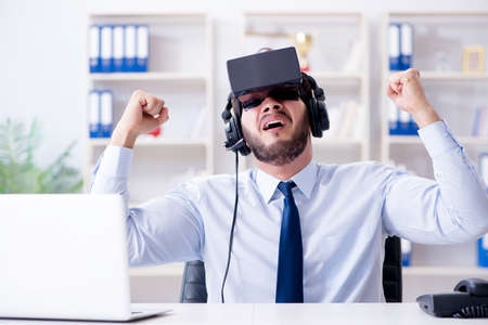 Businessman gamer in office playing gamesの写真素材